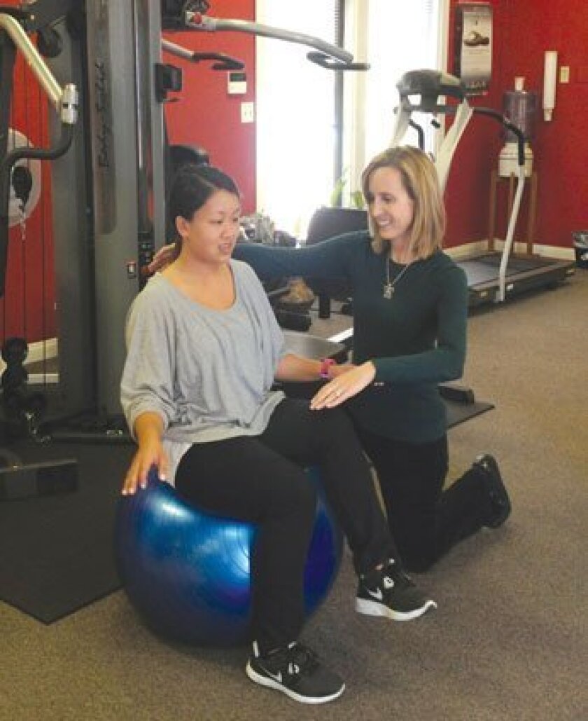 Julie Hom (right) of Ability Rehabilitation Specialists in La Jolla works with a patient. Courtesy Photo
