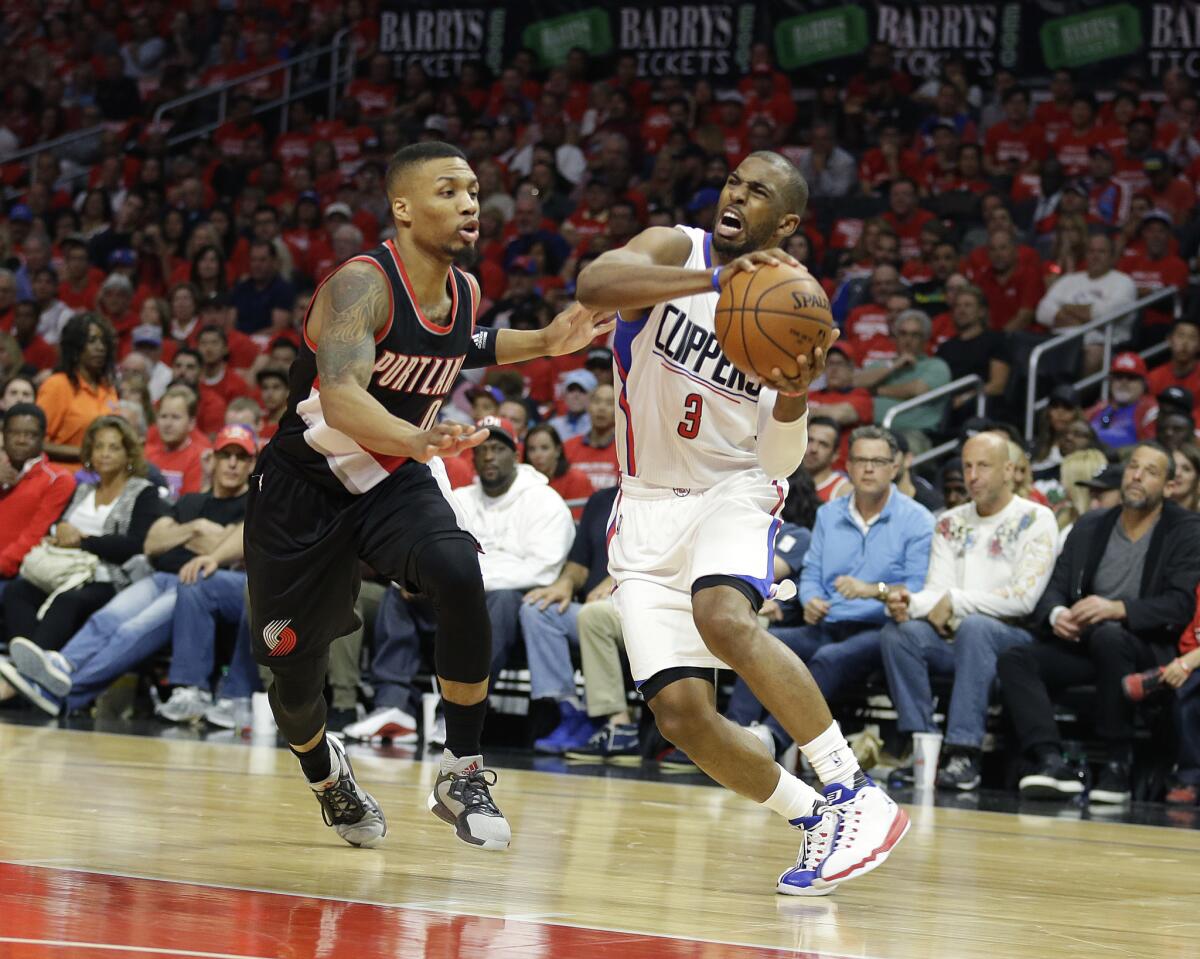 Clippers guard Chris Paul is pressured by Trail Blazers guard Damian Lillard on a drive during the first half of Game 1 on Sunday.