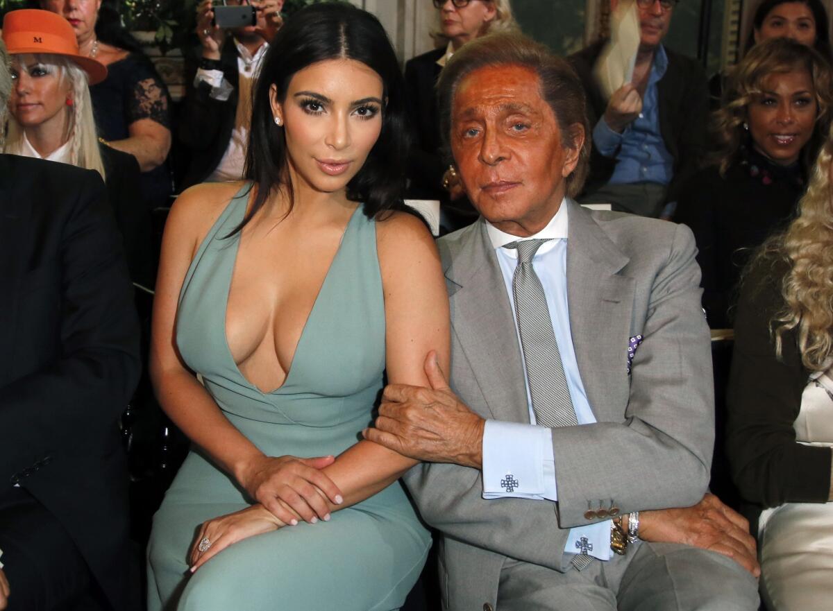 Kim Kardashian and fashion designer Valentino pose for photographers prior to the presentation of the Valentino Fall Winter 2014-15 Haute Couture fashion collection Wednesday in Paris.