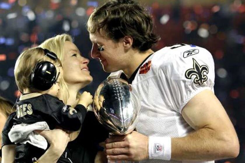 New Orleans Saints quarterback Drew Brees celebrates a 31-17 victory over the Indianapolis Colts with wife Brittany and son Baylen after Super Bowl XLIV at Sun Life Stadium in Miami Gardens. Brees, the game's MVP, completed 32 of 39 passes for 288 yards and two touchdowns. His 32 completions tied the Super Bowl record set by New England's Tom Brady in Super Bowl XXXVII. New Orleans became the fourth franchise to win the Super Bowl in their only appearance, joining Tampa Bay, Baltimore and the New York Jets.