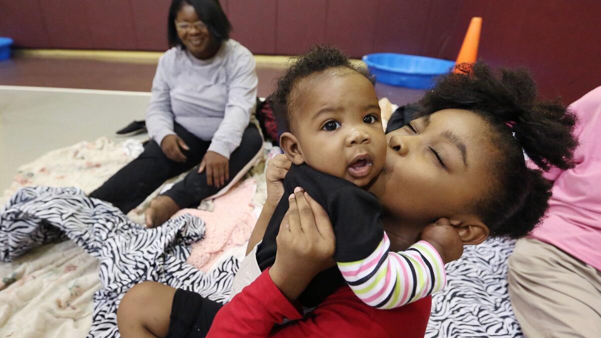 A family waits out Hurricane Irma at the Orlando Union Rescue Mission.