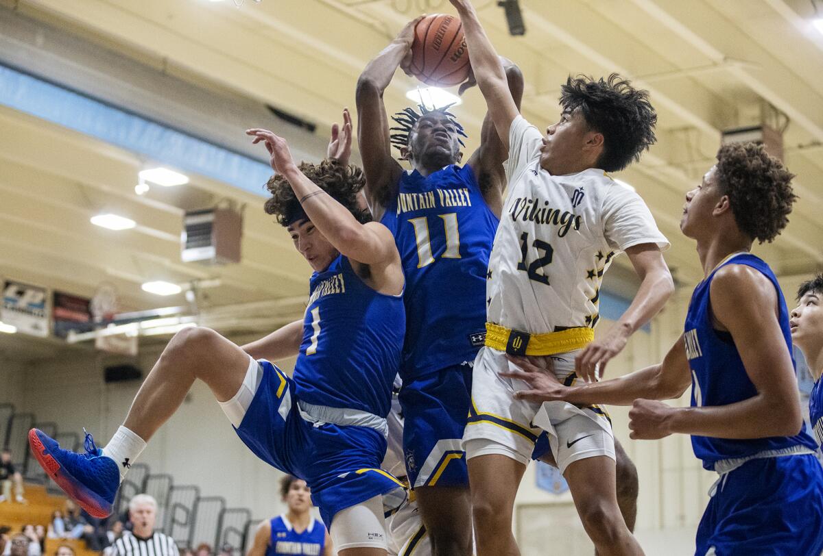 Jeremiah Whitmore, center, shown going up for a rebound on Tuesday, led Fountain Valley with 22 points on Friday night.