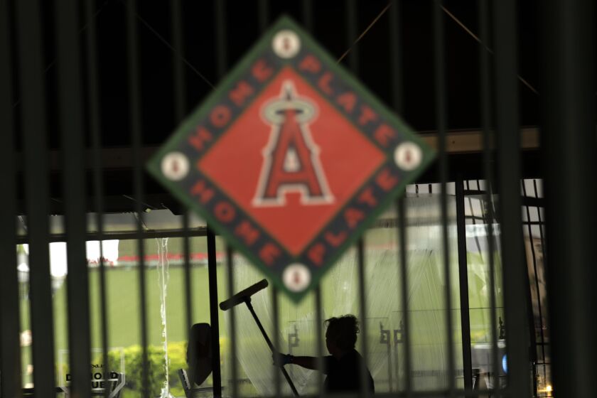 ANAHEIM, CA - MAY 23, 2022 - - A worker washes a window inside Angel Stadium in Anaheim on May 23, 2022.