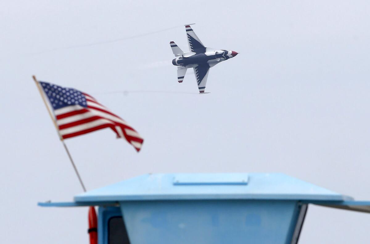 A solo Canadian Snowbird jet comes close to the beach on day one of the Pacific Airshow in Huntington Beach on Friday.