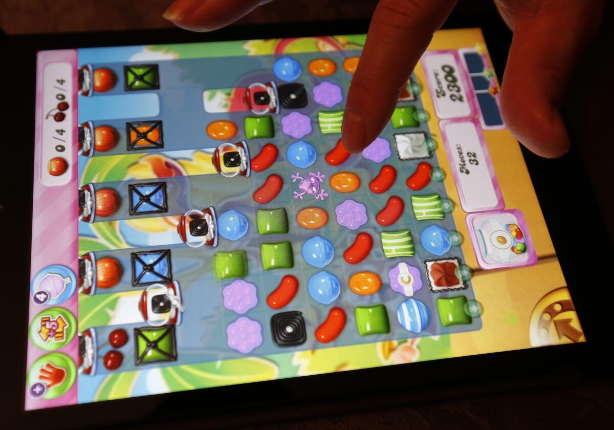 King Digital Entertainment's "Candy Crush Saga" is seen being played on an Apple iPad Mini the day after Activision Blizzard announced it will buy King Digital Entertainment.