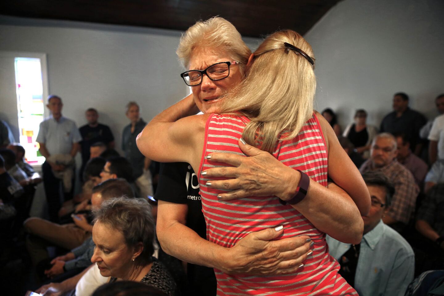 Susan Stephens, right, gets a hug from Karen Castelloes before a vigil and prayer service is held at Joy Meropolitan Community Church very close to Pulse nightclub.
