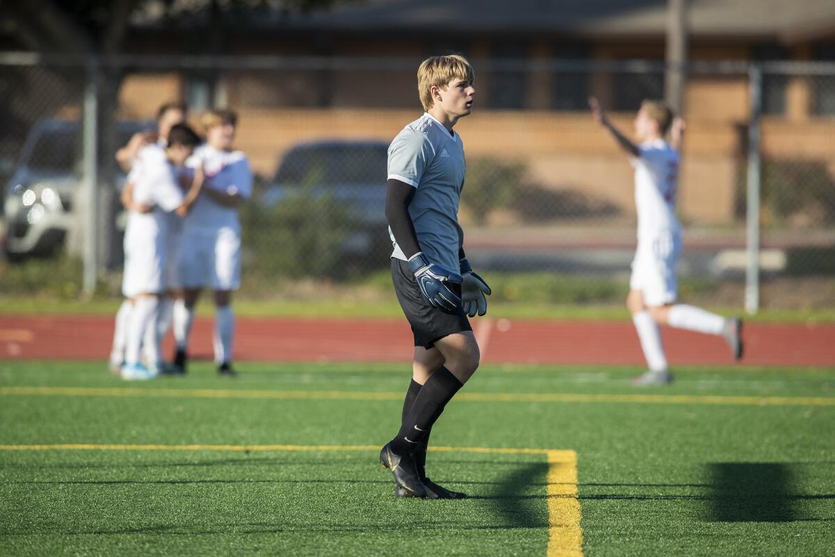 Fountain Valley goalkeeper Connor Trapp looks away as Mater Dei players celebrate a first-half goal in the first round of the CIF Southern Section Division 1 playoffs on Wednesday.