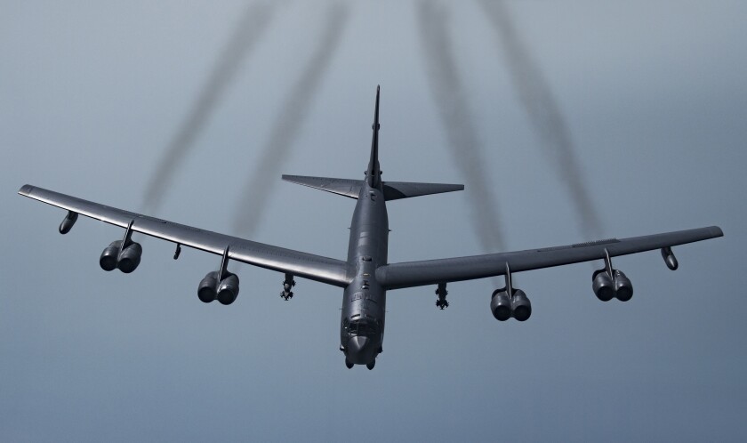 An American bomber aircraft flies, leaving four trails of exhaust.