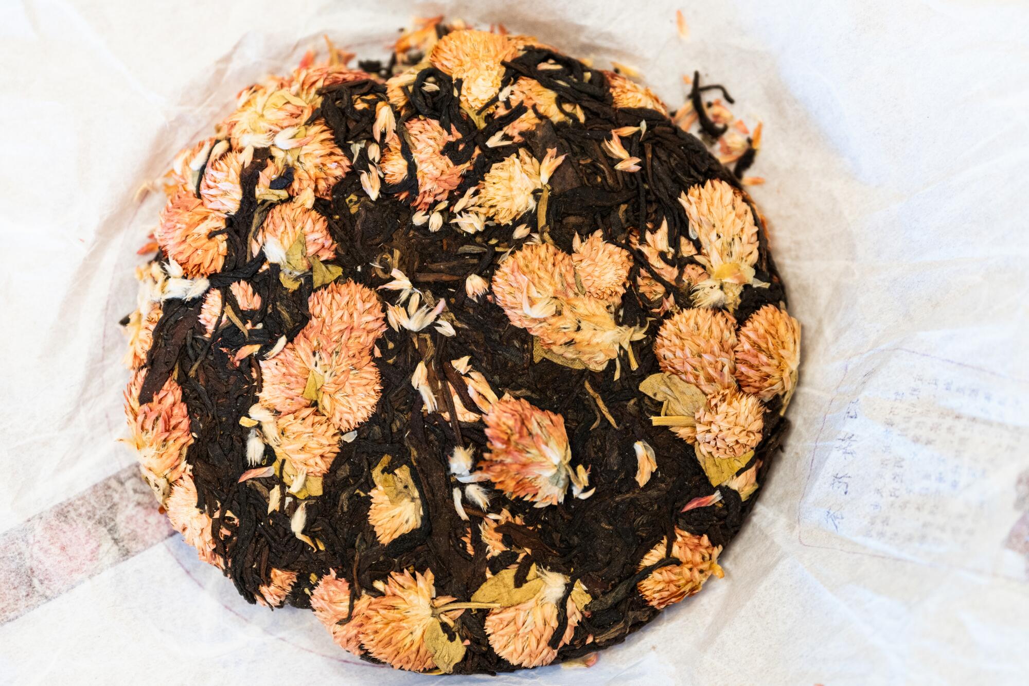 A unique tea cake studded with Chinese flowers at Grand Yunnan Tea.