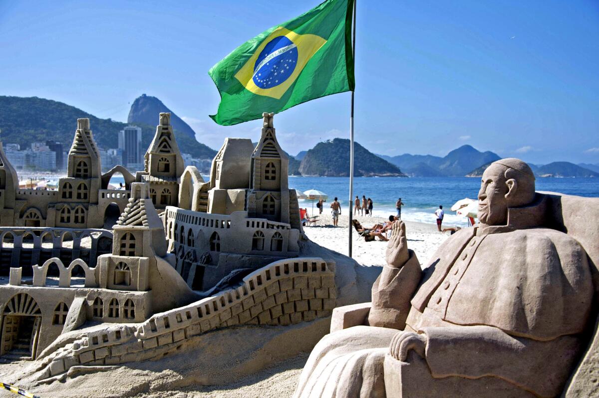 A sand sculpture on Rio de Janeiro's Copacabana Beach depicts Pope Francis days before the pontiff is to arrive in the city for World Youth Day, a major Roman Catholic youth festival.