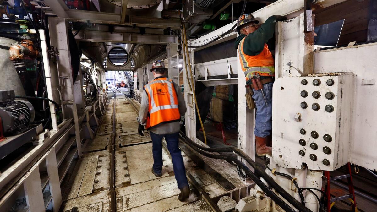 The hiring boom was led by 66,000 new construction jobs, the biggest increase in 11 years. Above, people work on a Los Angeles rail system connector.