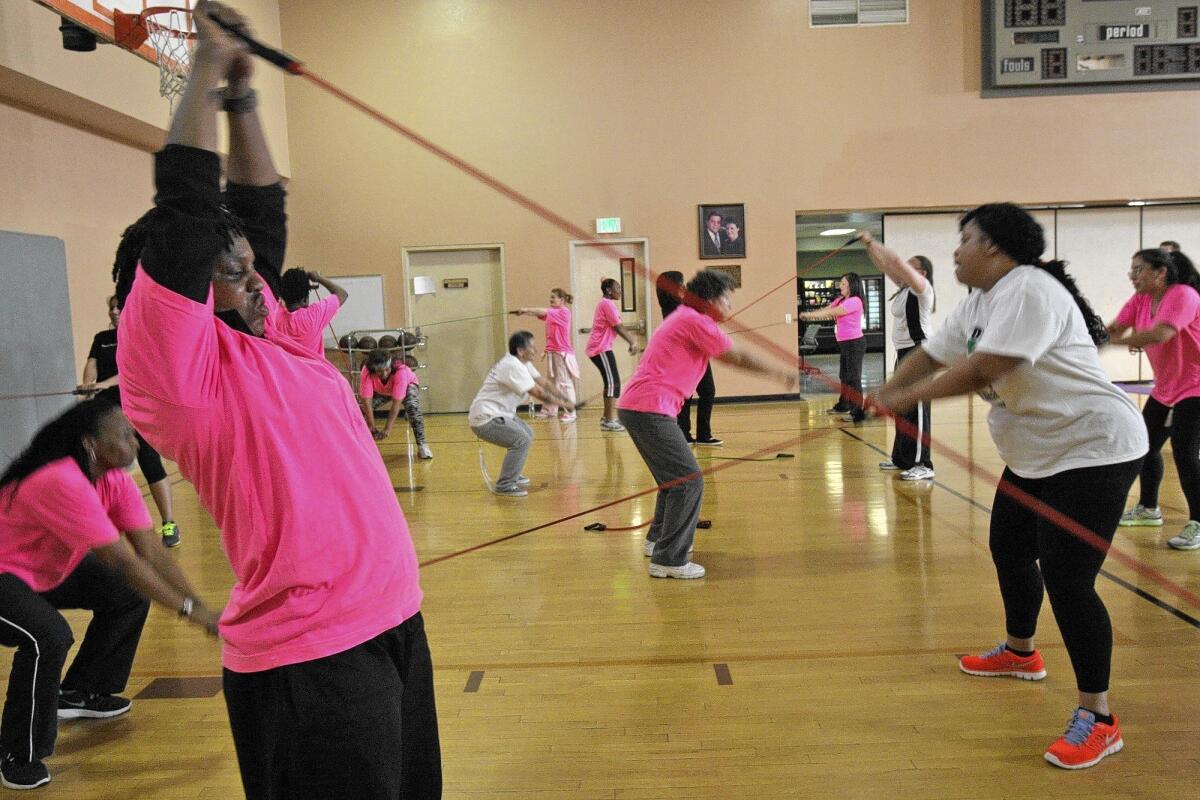 Residents of the Los Angeles Mission work out during a session with volunteer trainers as part of a nonprofit project called Urban Fitness 911.