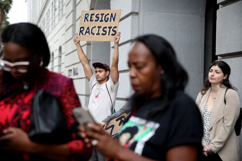LOS ANGELES, CA - OCTOBER 11: Francisco Espinosa, of Los Angeles, left, and other protestors in front of Los Angeles City Hall on Tuesday, Oct. 11, 2022 in Los Angeles, CA. Protestors want the resignation of Los Angeles Councilmembers Nury Martinez, Kevin de Leon and Gil Cedillo. Martinez made racist remarks about Councilmember Mike Bonin son in the recording as her colleagues, Councilmembers Kevin de Leon and Gill Cedillo, laughed and made wisecracks. (Gary Coronado / Los Angeles Times)