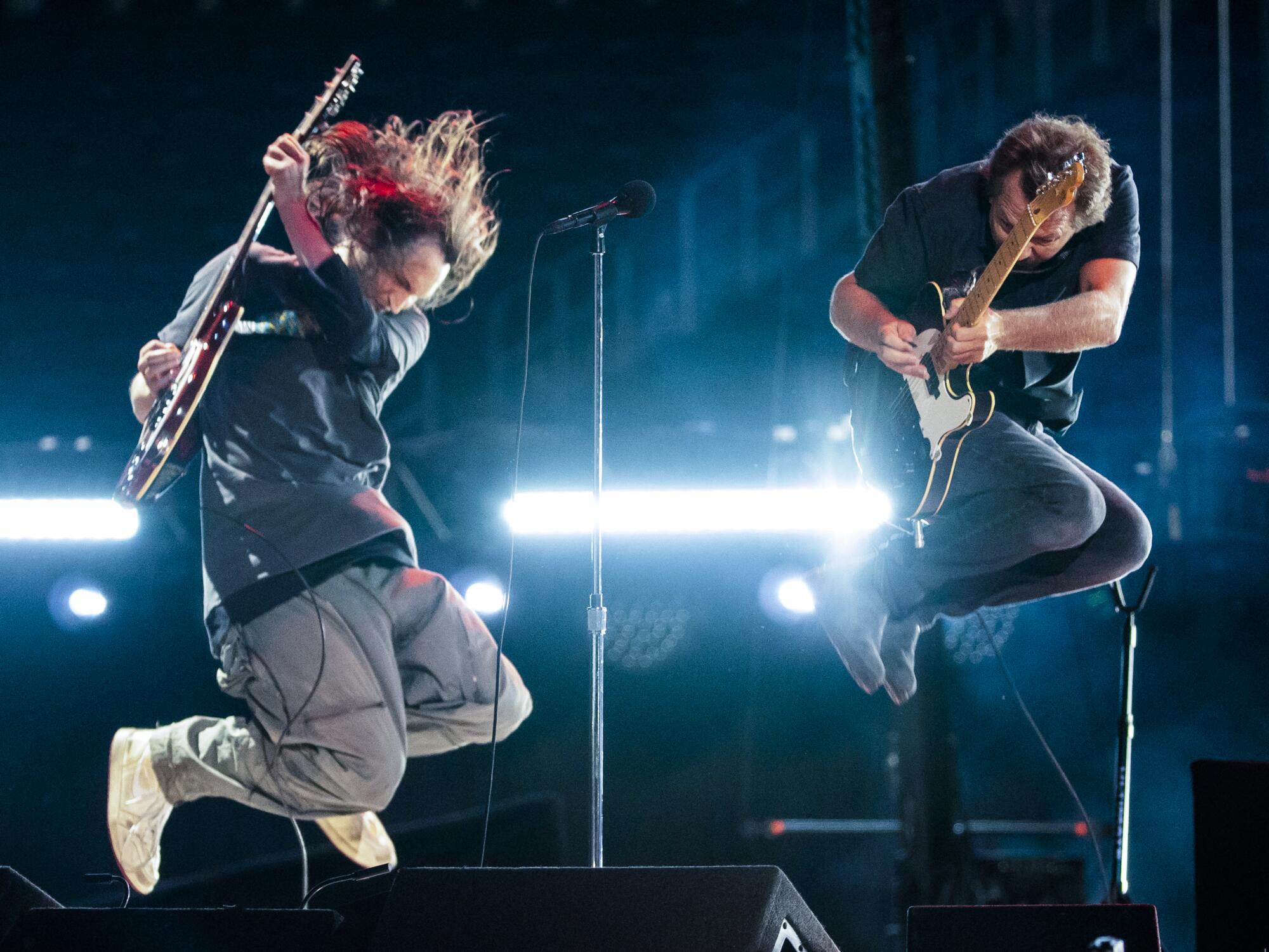 Josh Klinghoffer and Eddie Vedder jump at the Vax Live concert