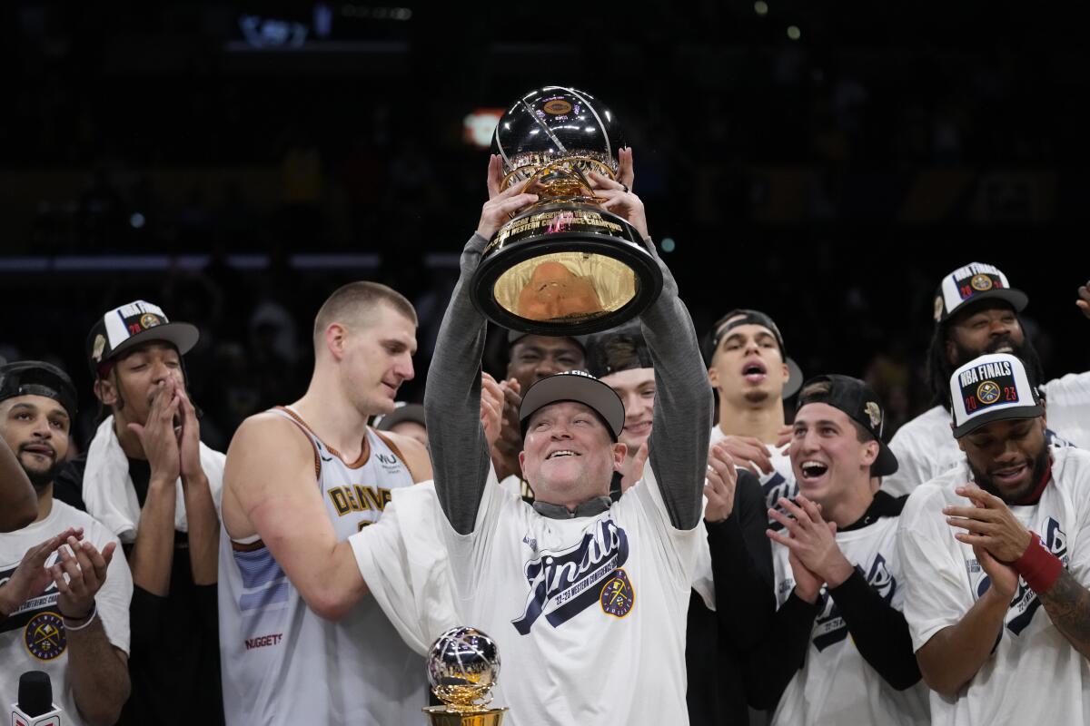 Denver Nuggets head coach Michael Malone holds the conference championship trophy after Game 4 of the NBA basketball Western Conference Final series against the Los Angeles Lakers Monday, May 22, 2023, in Los Angeles. Denver won 113-111 to win the series. (AP Photo/Ashley Landis)