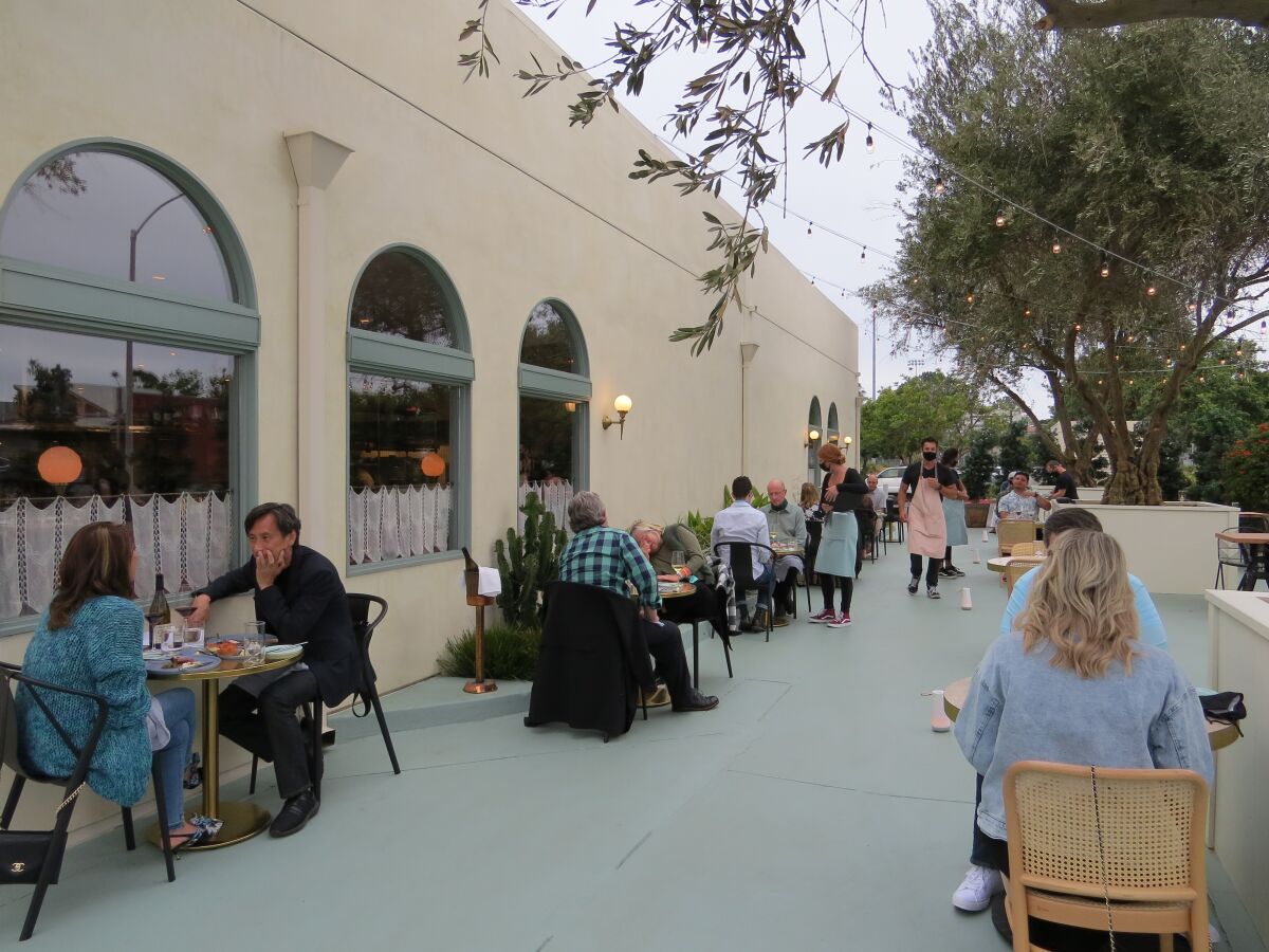 Diners sit at socially distanced tables at newly opened Jeune et Jolie: Starry Night on June 23.