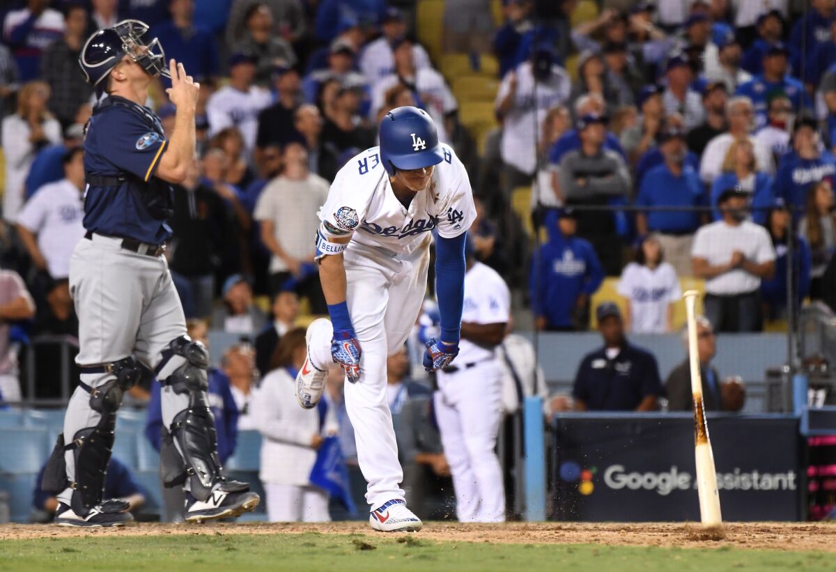 Dodgers Cody Bellinger throws his bat after popping-up with runners in scoring position against the Brewers in the 9th inning in Game 3 of the NLCS at Dodger Stadium.