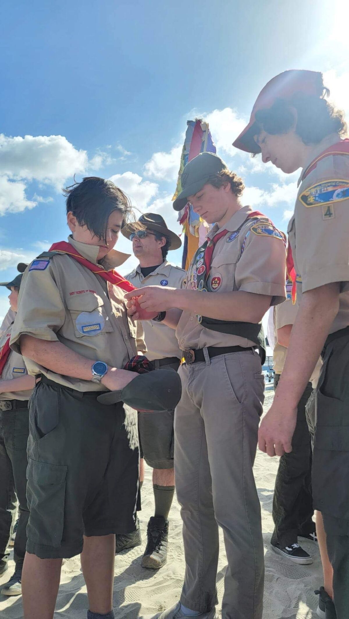 La Jolla Cub Scouts are given new Boy Scout neckerchiefs by fellow Scouts.