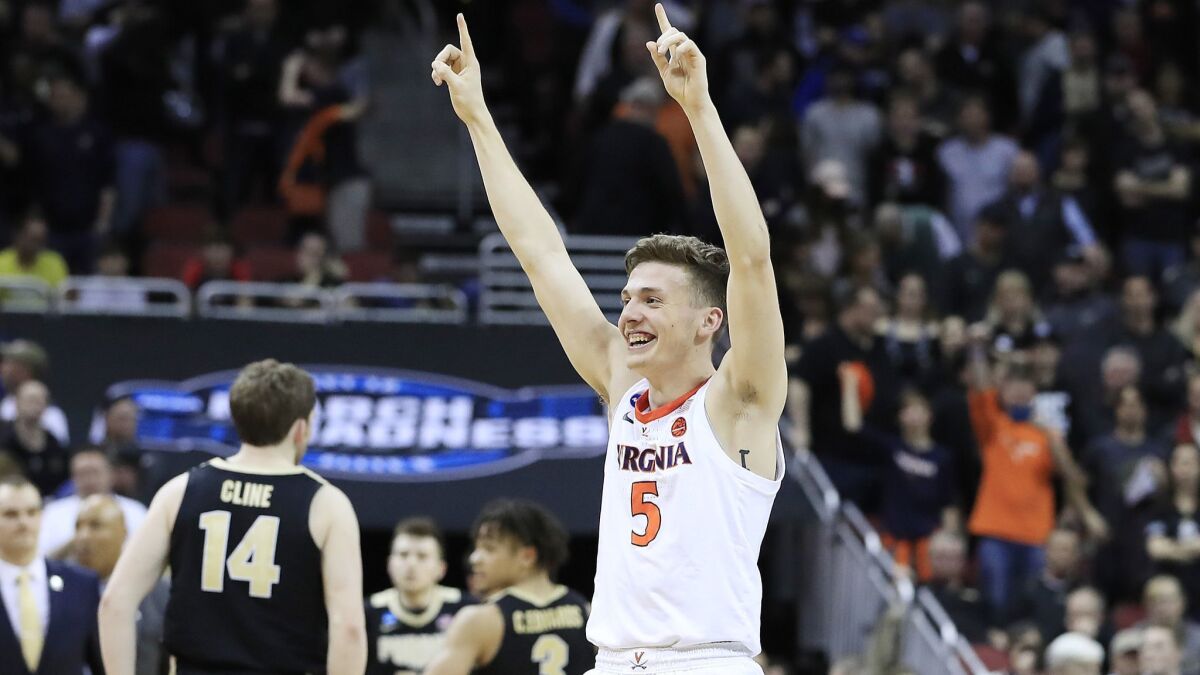Kyle Guy of the Virginia Cavaliers celebrates after defeating the Purdue Boilermakers 80-75 to advance to the Final Four in overtime.