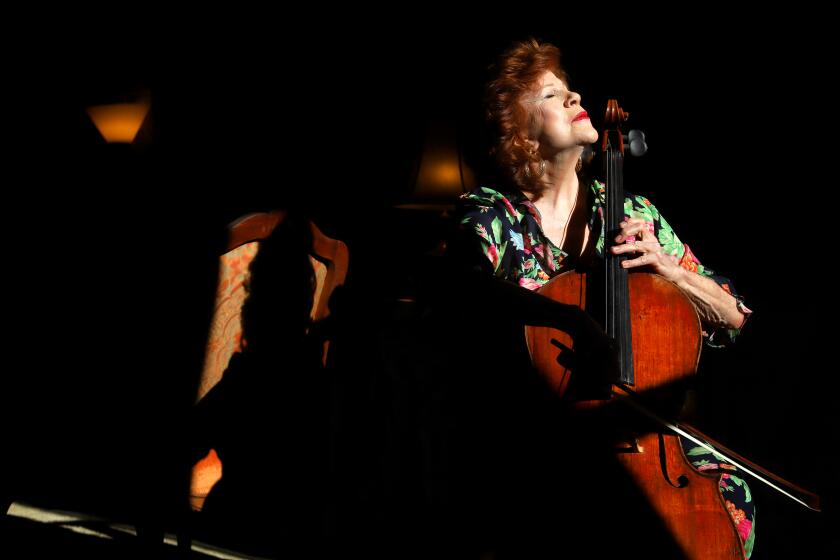 NEW YORK, N.Y. -- MONDAY, FEBRUARY 3, 2020 -- Christine Walevska is a master cellist who has played all over the world during her long career. When she was young she played on a rare Bernardel cello that was stolen in 1976 and remained missing until 2014. Originally custom-made for the young daughter of a French aristocrat two centuries ago, it's a one-of-a-kind, one-eighth size cello. Walevska was photographed in her Manhattan, New York apartment with another cello that was made in 1740. ( Rick Loomis / for the Los Angeles Times ) Assignment ID: 487196