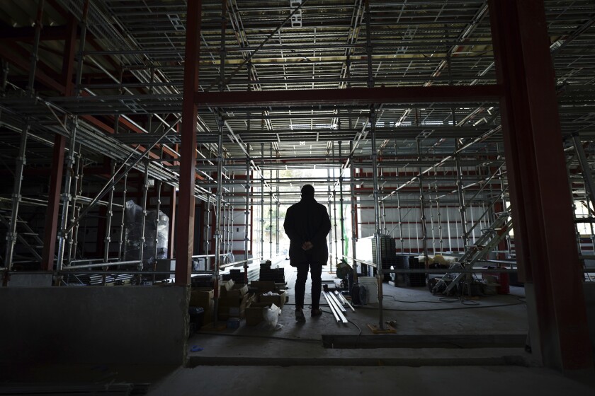 A person stands in a construction site