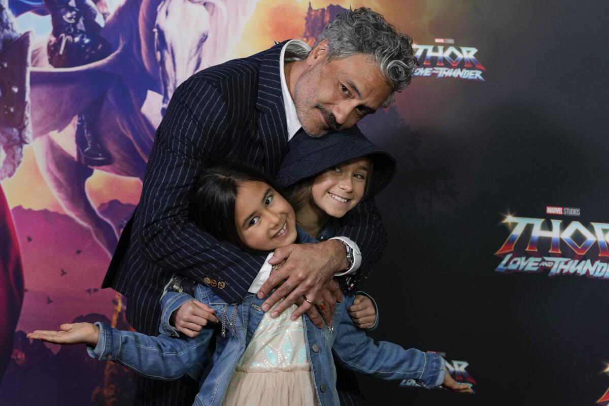 New Zealand director Taika Waititi poses for a photo with his daughter's Matewa Kiritapu and Te Hinekahu during a red carpet event for the movie premiere of "Thor: Love and Thunder" at the Entertainment Quarter in Sydney,Australia, Monday, June 27, 2022.(AP Photo/Mark Baker)