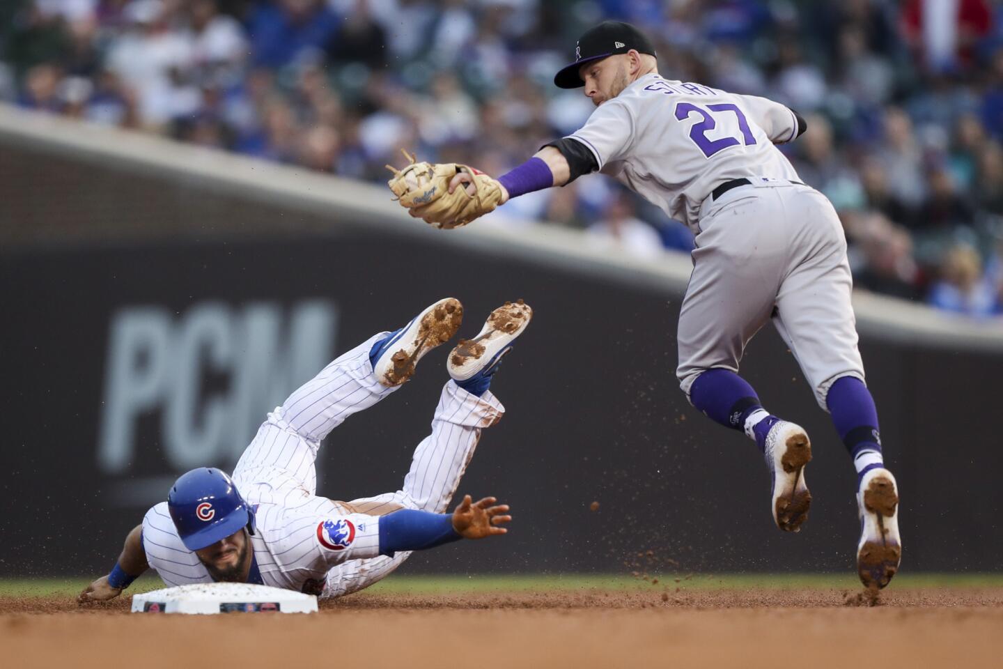 Colorado Rockies shortstop Trevor Story tags out Chicago Cubs third baseman David Bote during the third inning at Wrigley Field, June 5, 2019.