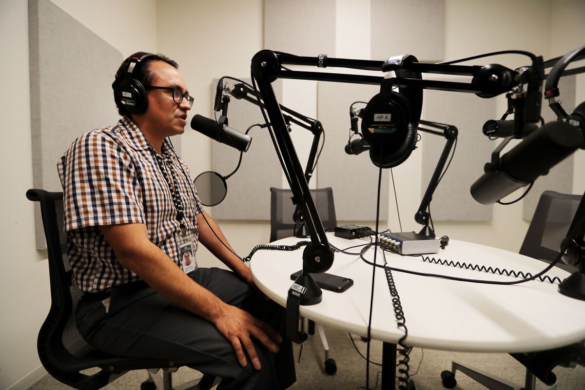 Reporter Gustavo Arellano in the recording studio working on his podcast, “This is California: The Battle of 187.”