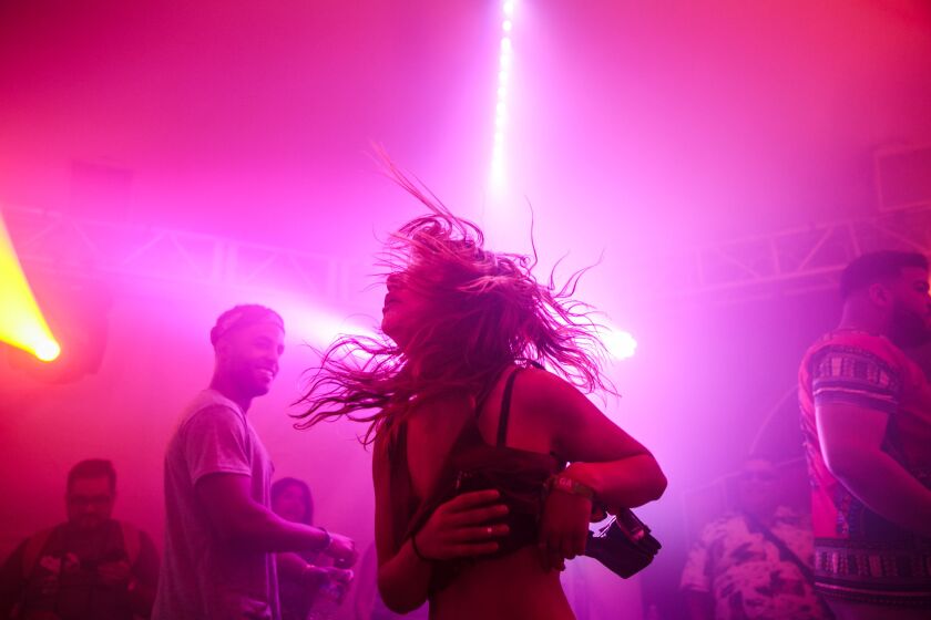 A music fan flings her hair to the beats of EDM music during Weekend 2 of the Coachella Valley Music and Arts Festival in Indio, Calif., on April 17, 2015.