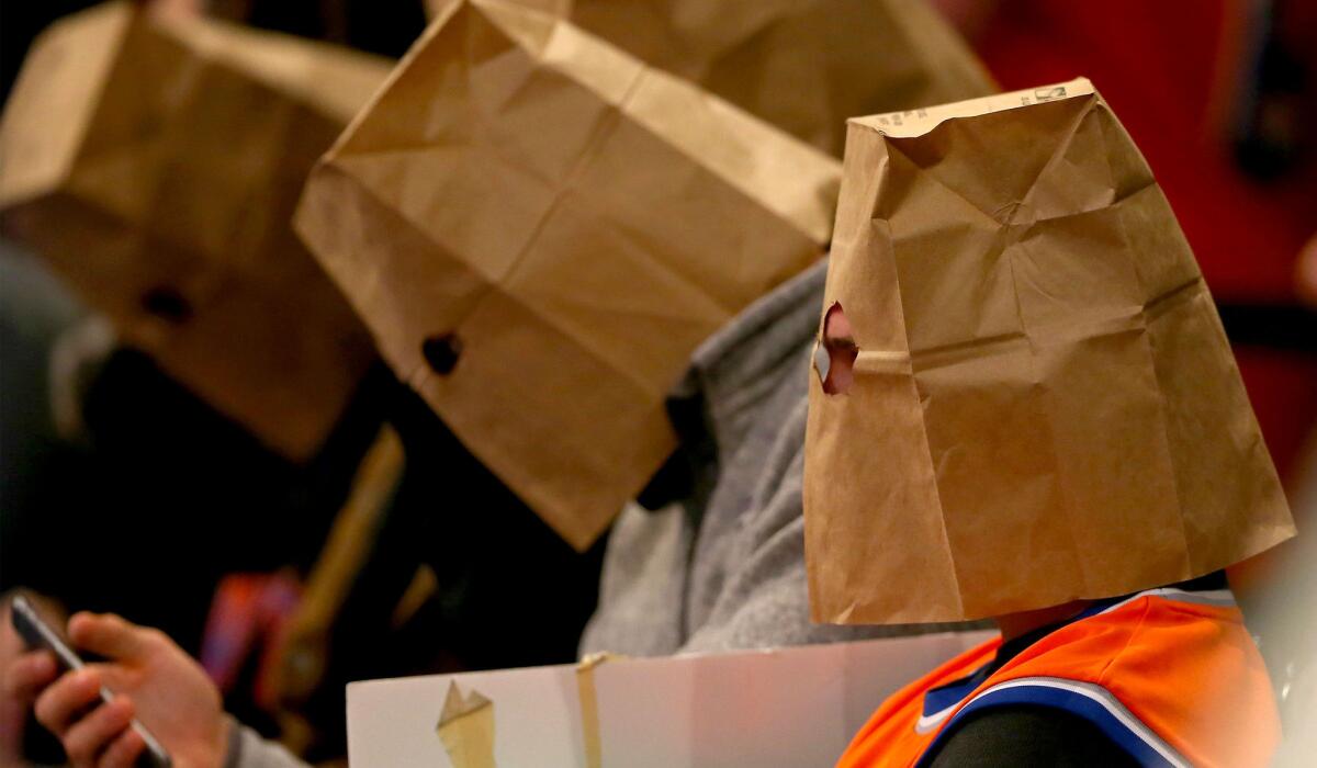 Knicks fans wear bags over their heads during another loss at Madison Square Garden on Thursday night.