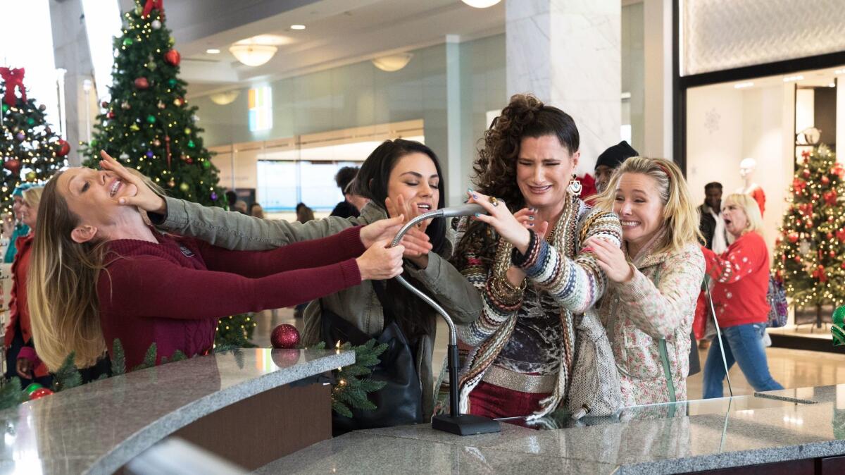 Mila Kunis, center, Kathryn Hahn and Kristen Bell in a scene from "Bad Moms 2."