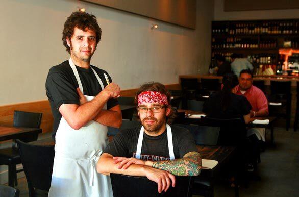 Jon Shook, left, and Vinny Dotolo are the chef-owners of Animal restaurant on Fairfax Avenue in Los Angeles.