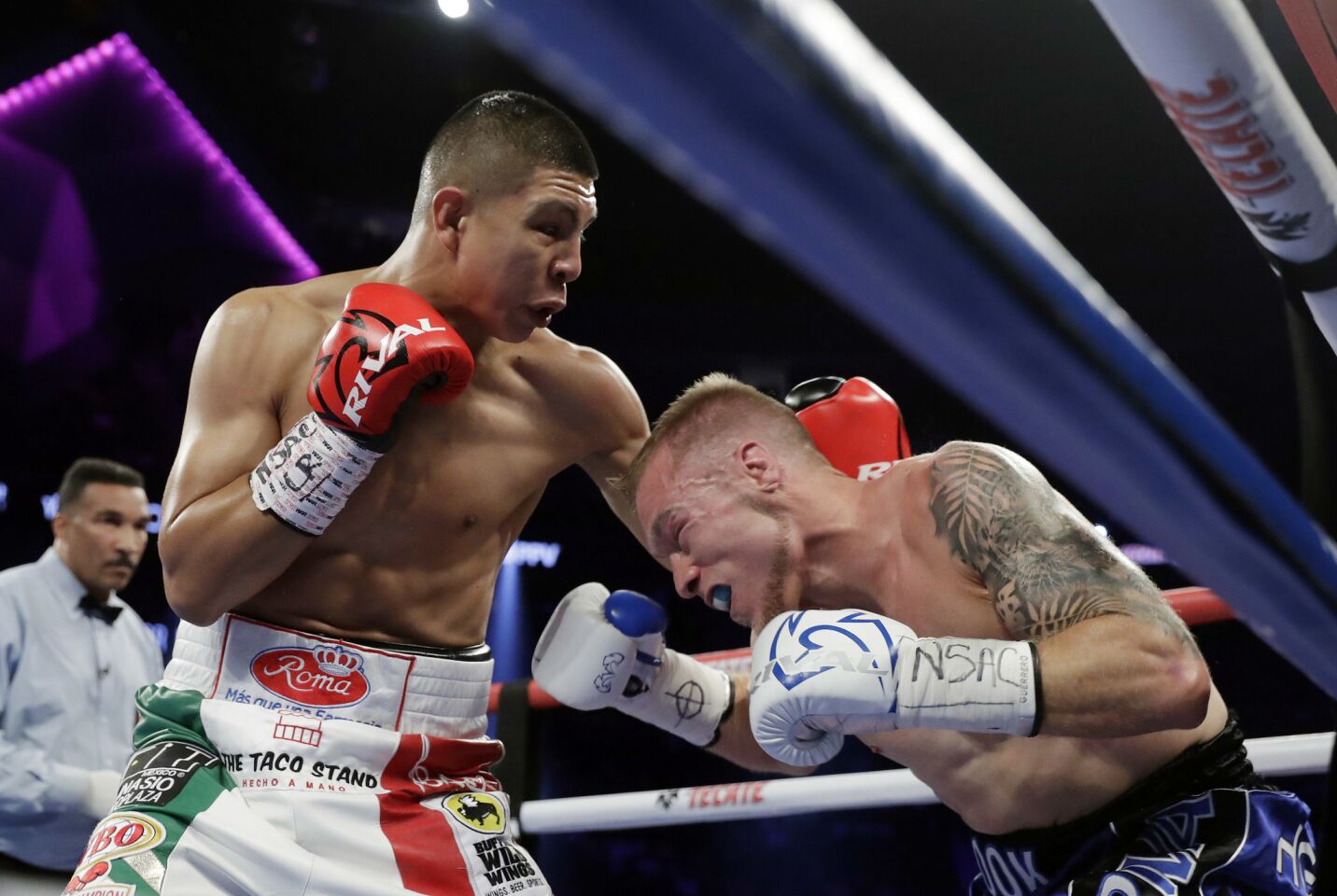 Jaime Munguia, left, punches Brandon Cook during their WBO junior middleweight championship boxing match, Saturday, Sept. 15, 2018, in Las Vegas. Munguia won by TKO.