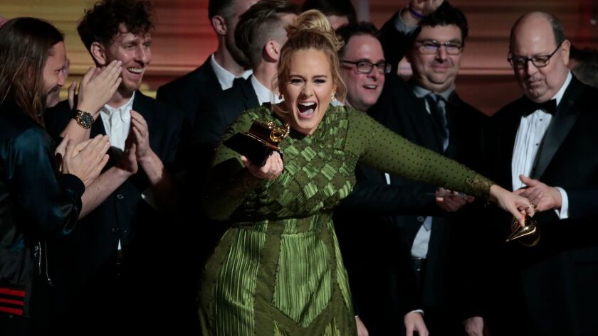 Adele shows her delight in February after winning the Grammy for album of the year.