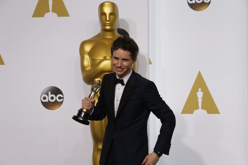 "The Theory of Everything" star Eddie Redmayne poses backstage after winning the lead actor category at the 87th Academy Awards.