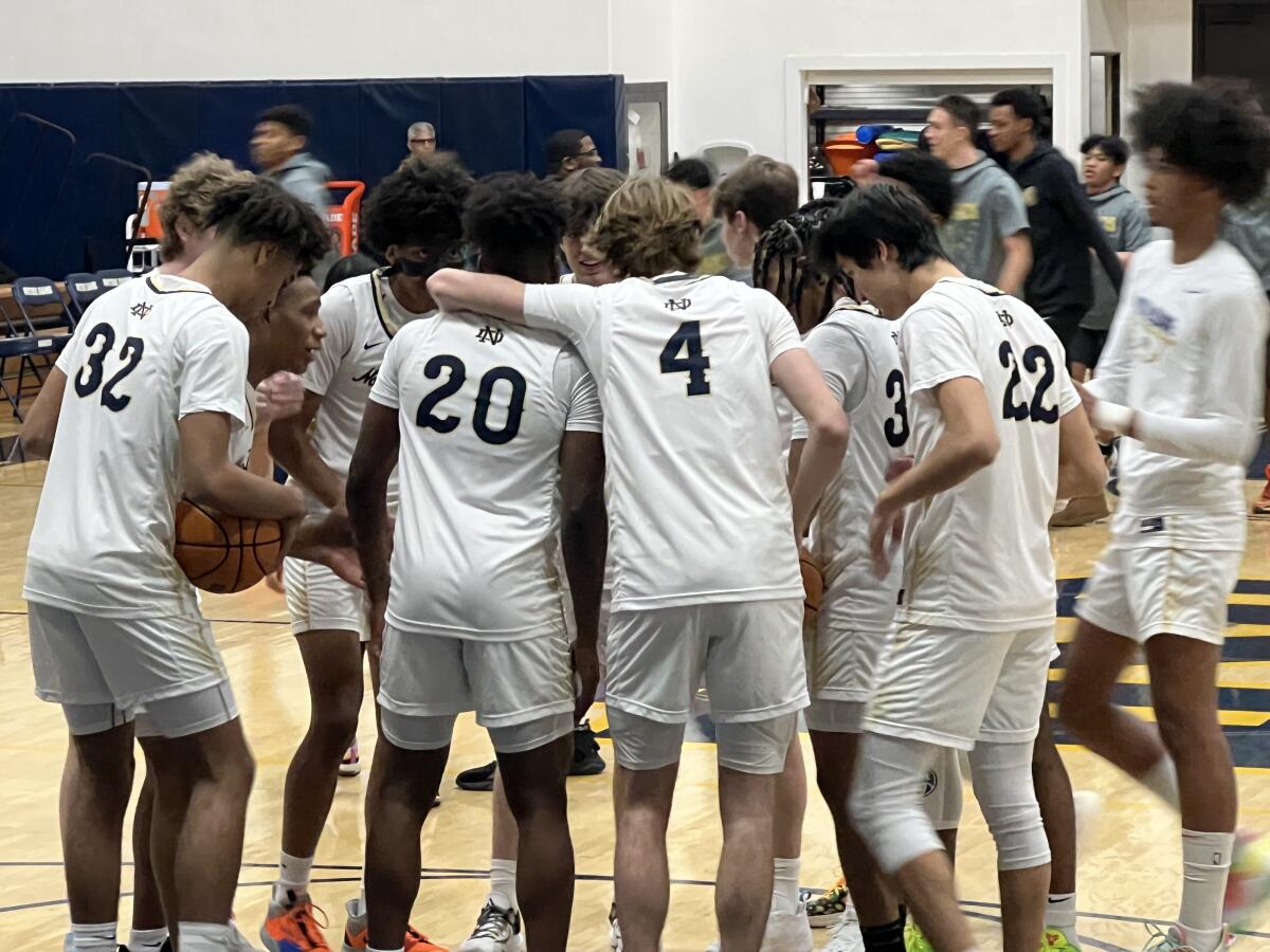 Sherman Oaks Notre Dame basketball players gather before their game against St. Francis. 