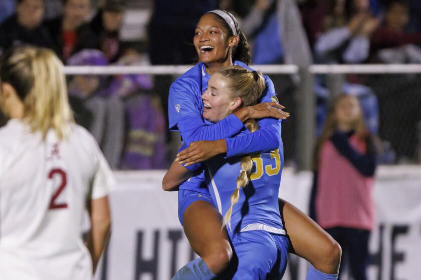UCLA's Reilyn Turner, top, celebrates with Ally Cook (33) after scoring a goal during the first half.