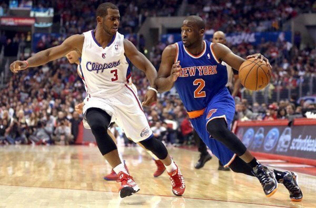 Clippers point guard Chris Paul tries to cut off a drive by Knicks point guard Raymond Felton in the first half of their game on Wednesday at Staples Center.