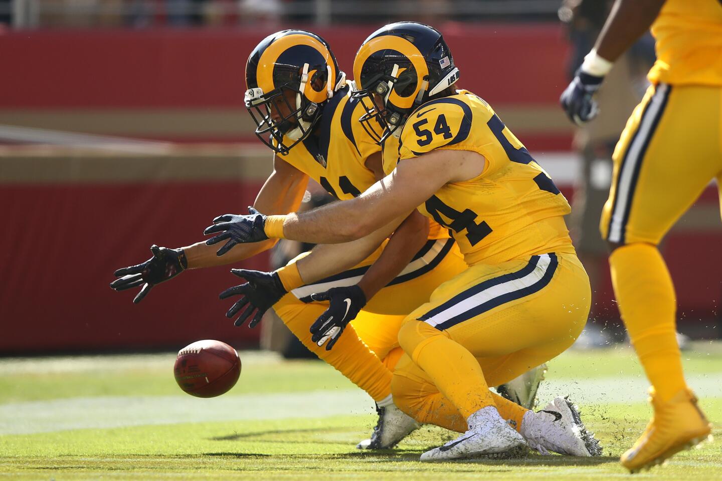 KhaDarel Hodge #11 and Bryce Hager #54 of the Los Angeles Rams dive for a blocked punt in the endzone during their NFL game against the San Francisco 49ers at Levi's Stadium on October 21, 2018 in Santa Clara, California.