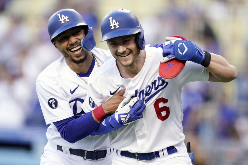 Los Angeles Dodgers' Trea Turner, right, celebrates after his two-run home run with Mookie Betts.