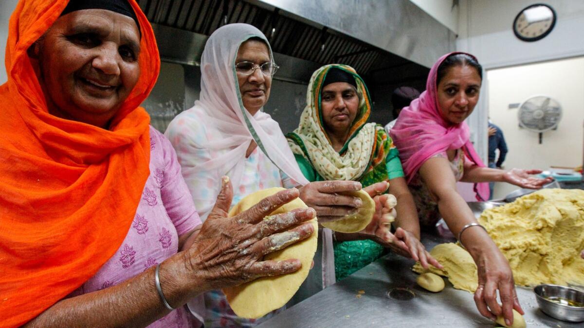 Sikh women prepare bread during Nagar Kirtan celebrations at Gurdwara Guru Angad Darbar in Bakersfield. (Irfan Khan / Los Angeles Times)