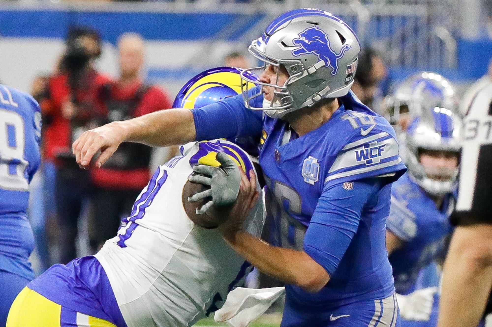 Rams defensive tackle Kobie Turner hits Detroit Lions quarterback Jared Goff during the first half at Ford Field.