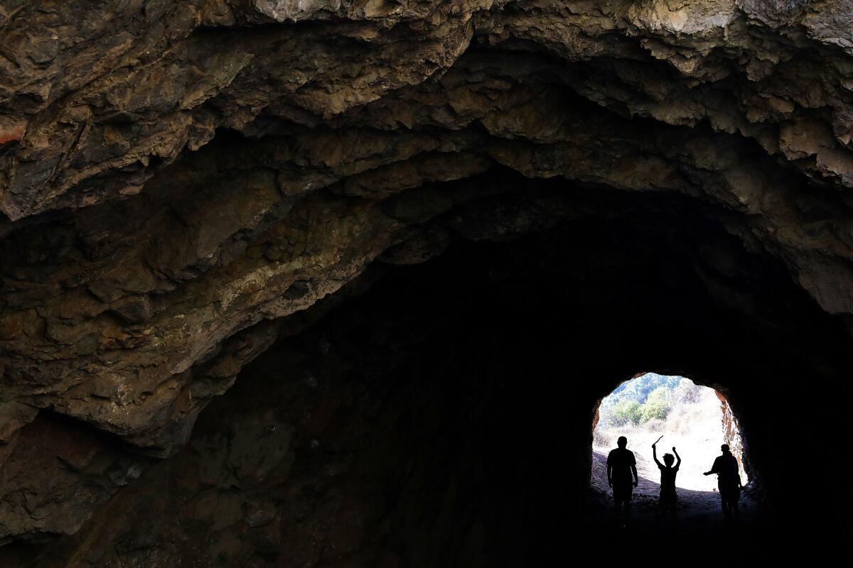 LOS ANGELES-AUGUST 23, 2020: Visitors walk through Bronson Cave at Griffith Park in Los Angeles on Sunday, August 23, 2020. (Christina House / Los Angeles Times)