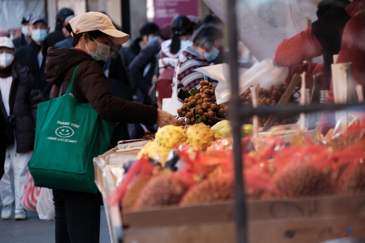 People shop for food at an outdoor market in New York City on Nov. 5.