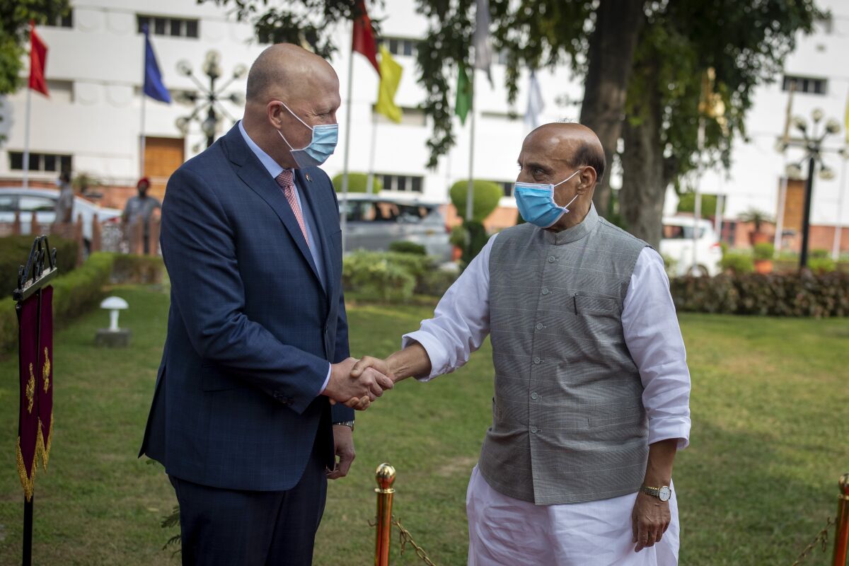 Indian Defense Minister Rajnath Singh, right, welcomes his Australian counterpart Peter Dutton as he arrives for a Guard of Honor in New Delhi, India, Friday, Sept. 10, 2021. (AP Photo/Altaf Qadri)