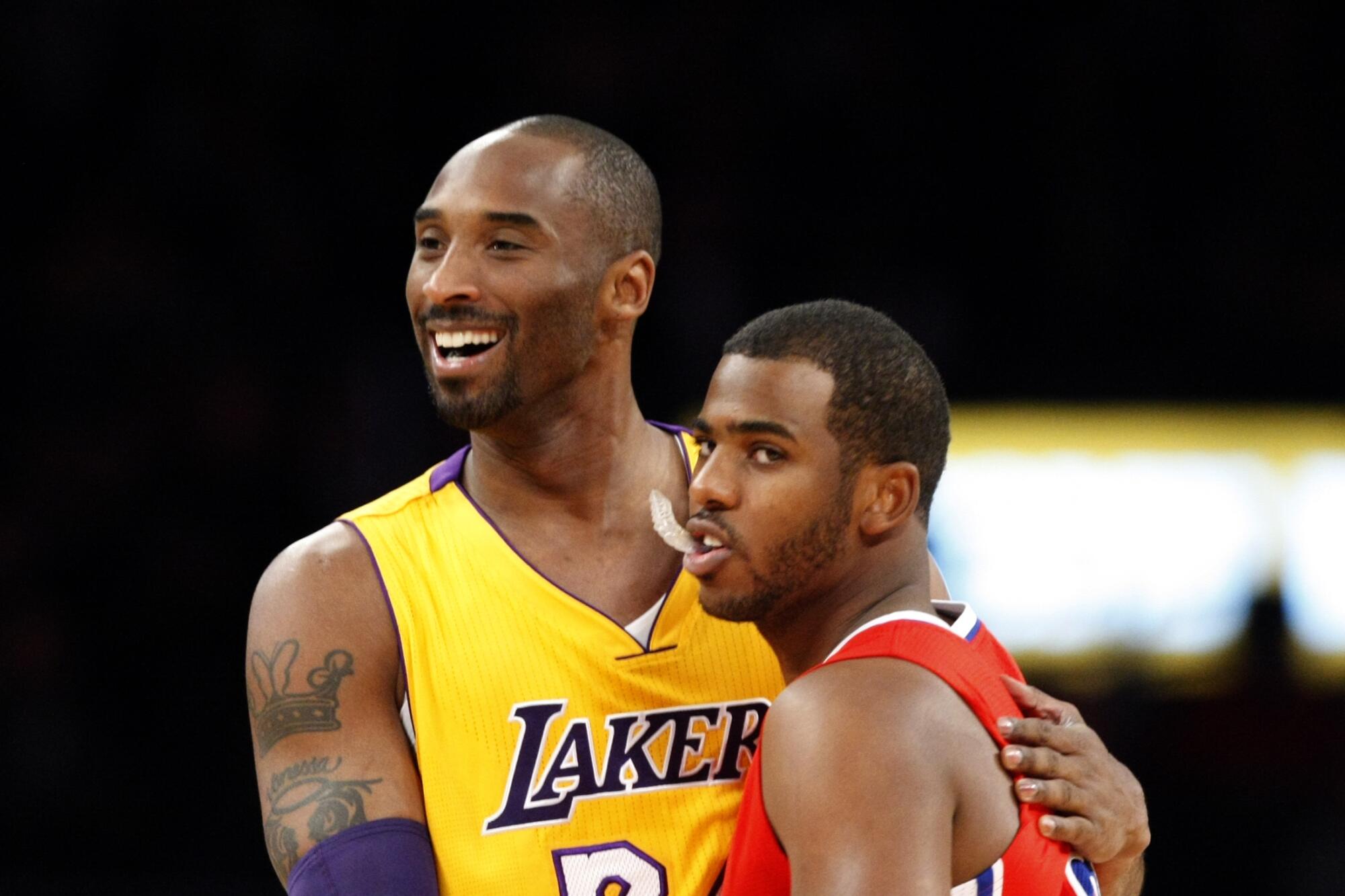 All-Star guards Kobe Bryant, left, and Chris Paul embrace before a Lakers-Clippers preseason game in 2011.
