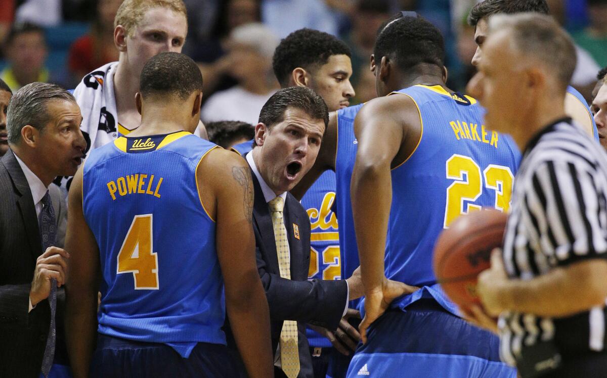 UCLA Coach Steve Alford talks to his players during a timeout in the Pac-12 conference tournament.