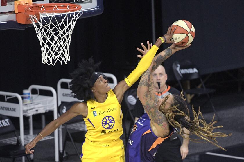 Los Angeles Sparks guard Brittney Sykes, left, blocks a shot by Phoenix Mercury center Brittney Griner during the first half of a WNBA basketball game, Saturday, July 25, 2020, in Ellenton, Fla. (AP Photo/Phelan M. Ebenhack)