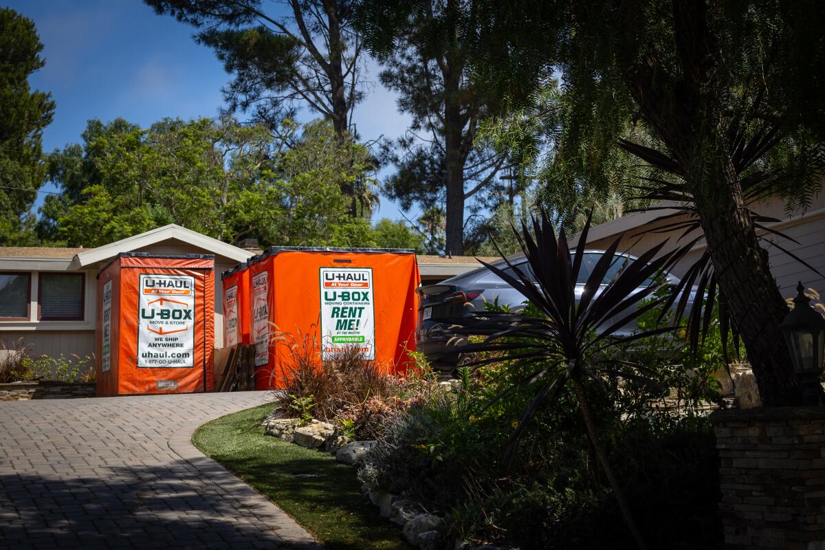 Large moving containers outside a home in the Portuguese Bend community.