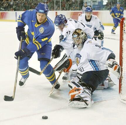 Finland goalie Antero Niittymaki makes a save on Sweden's Fredrik Modin